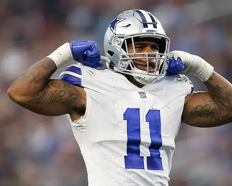 Dallas Cowboys football player celebrating on the field.