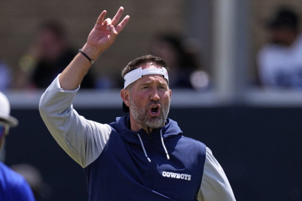 Dallas Cowboys' Head Coach Brian Schottenheimer giving hand signs at practice. Cowboys Fans Shouldn't Panic After 1st Preseason Game